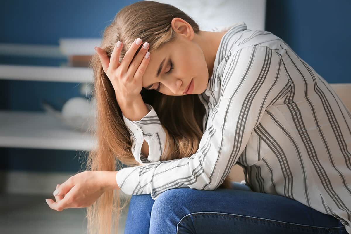 young woman struggling with addiction withdrawal definition